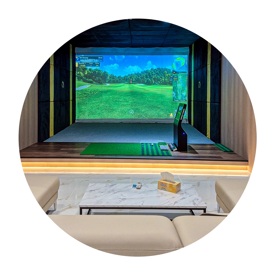 Indoor golf simulator bay with a large projection screen displaying a golf 